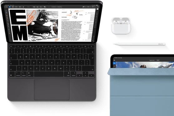iPad Pro attached to Magic Keyboard, front exterior, space black color, rounded corners, black display bezel, open, display showing article editing app with text and photograph of a woman playing music, Airpods 4 in open case, blue Smart Folio cover on iPad Pro with Apple Pencil Pro resting atop device, cover slightly open revealing display