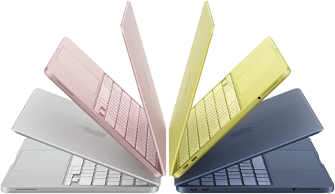 MacBook Neo laptops in silver, blush, citrus, and indigo colors, slightly open and arranged in an arch formation