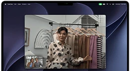 A video call on a MacBook Pro where a woman shows fabrics to two people on the call, with Center Stage keeping her centered in the frame as she moves around