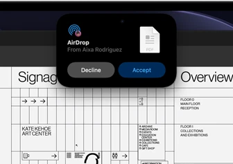 Display shows Dynamic Island with an AirDrop request in a small window over an open Adobe Acrobat file