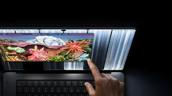 MacBook Pro with PROLED XDR Display, space black color, user resizes a window on screen with their fingertip